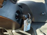 a key hanging from the handle of a motorcycle