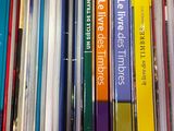 a lot of books that are stacked on top of each other