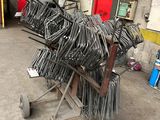 many pieces of metal sitting on a cart in a warehouse