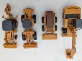 four toy vehicles that are lined up on a table