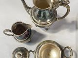 a silver tea pot and a silver teapot on a table