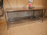 a stainless steel table in the middle of a room