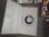 a video game in a case on a table next to other video games
