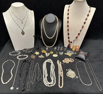 many necklaces and bracelets on display on a table