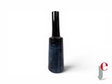 a bottle of nail polish sitting on a white surface