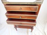 a wooden dresser with three drawers on top of it