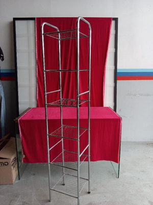 a metal shelf with a red table cloth on it