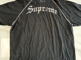 black supreme t - shirt with white lettering on the chest