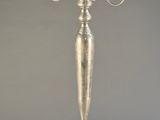 silver plated candelab with three candles on a stand