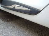 a close up of a car door handle on the side of the road