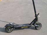 a scooter that is sitting in the parking lot