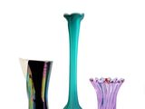 three vases sitting next to each other on a white surface