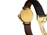a close up of a wrist watch with a brown strap