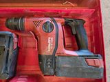 a red tool box with a cordless drill and two batteries