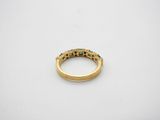 a close up of a gold ring on a white surface
