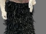 an image of a mannequin dressed in black feathers and a white blouse