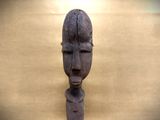 a wooden sculpture of a man with a face on it