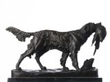 a bronze statue of a dog with a bird in it ' s mouth