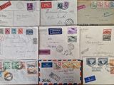 several envelopes of different sizes and colors are sitting on a table
