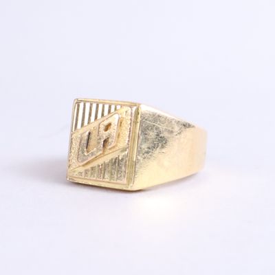 an image of a gold signet ring on a white surface