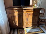 a tv that is sitting on top of a wooden cabinet