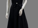 black dress on mannequin with buttons and collared neckline
