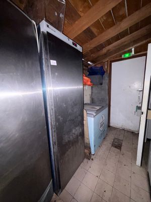 an image of a kitchen with a refrigerator and a refrigerator freezer