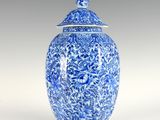 a blue and white vase with a lid sitting on a table
