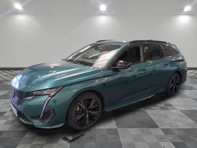 a blue car is parked on a checkered floor in a showroom