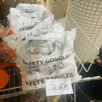 bags of safety goggles on a wire rack in a store