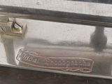 a silver toaster with a metal handle on a table