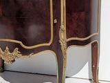 a small cabinet with a mirror on top of it