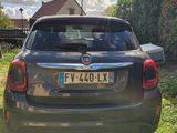 the back end of a grey fiat suv parked in a grassy area