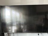 a flat screen tv sitting on a stand in the living room