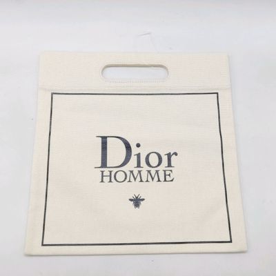 DIOR HOMME. Tote-bag en toile tissée naturelle, flocage sur …