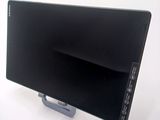 a black computer monitor on a stand on a white surface