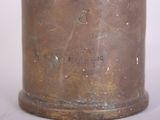 a metal container with a handle on a white surface