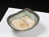 a small bowl sitting on top of a white table