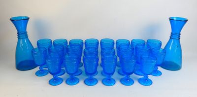 a lot of blue glass vases and glasses on the table
