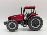 a red tractor that is sitting on a white surface