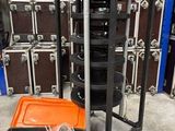 une valise noire et orange posée à côté d'une pile de valises noires et orange