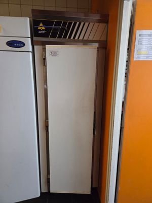 two white refrigerators in a kitchen next to each other