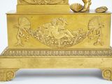 a gold clock that is sitting on top of a table