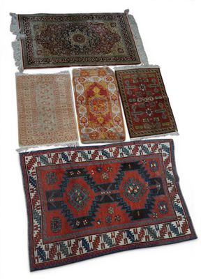several oriental rugs are arranged in a row on a white surface
