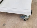 an image of a close up of a piece of furniture on wheels