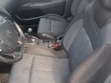 the interior of a car with black leather seats and a steering wheel