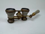 an old brass telescope with a wooden handle on a white surface