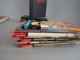 many books stacked on top of each other on a table