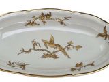 a plate with a bird design on it on a white background