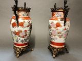 pair of antique chinese vases on stands on a gray background
